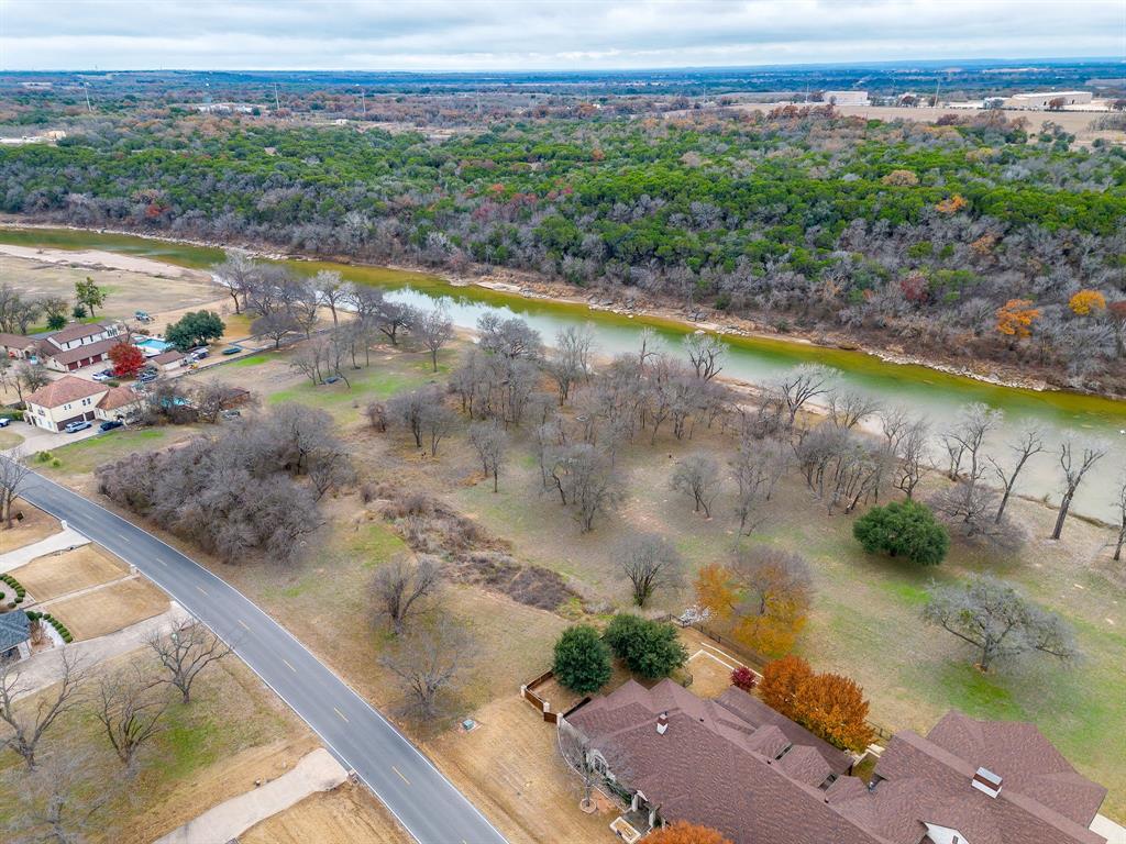 9314 Bellechase Road Granbury, TX 76049 - Photo 4 of 26 a view of a lake with a yard