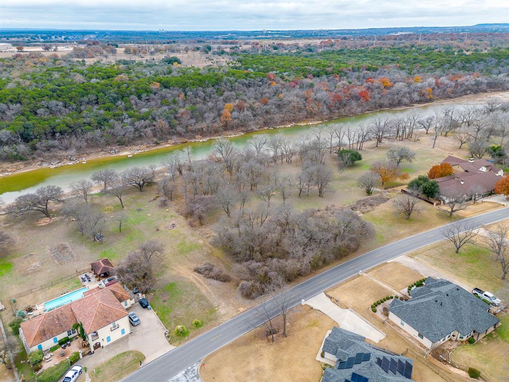 9314 Bellechase Road Granbury, TX 76049 - Photo 5 of 26 a view of a lake with a mountain in the background