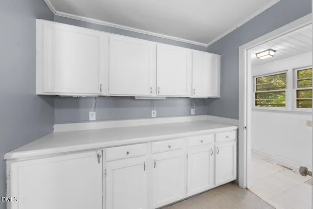 a kitchen with white cabinets and a sink