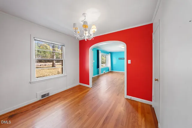 a view of a livingroom with wooden floor and a ceiling fan