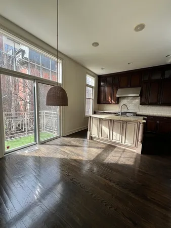 a view of a kitchen with wooden floor and a kitchen