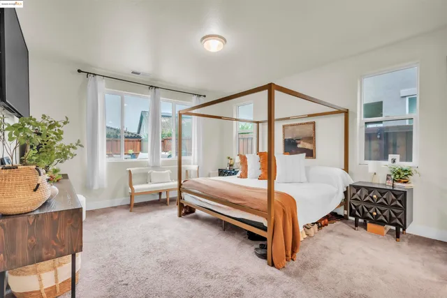 a bed room with a bed and a chair