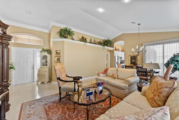 a living room with furniture a rug and a chandelier