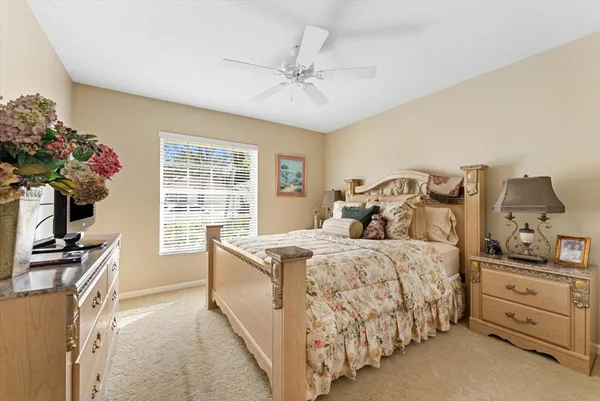 a bedroom with a bed dresser and a window