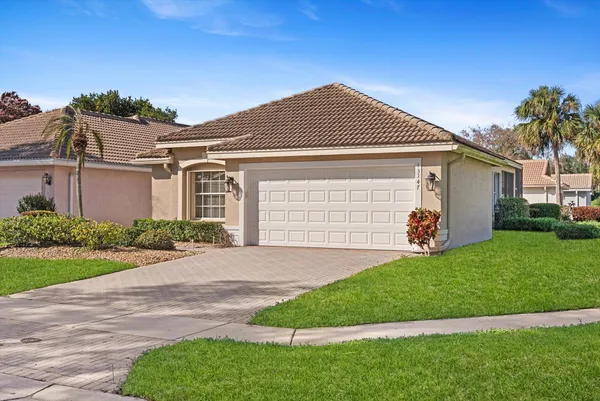 a front view of a house with a garden
