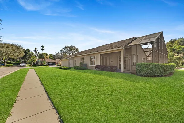 a front view of a house with yard and green space