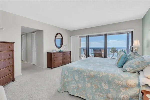 a bedroom with a large bed and a large window