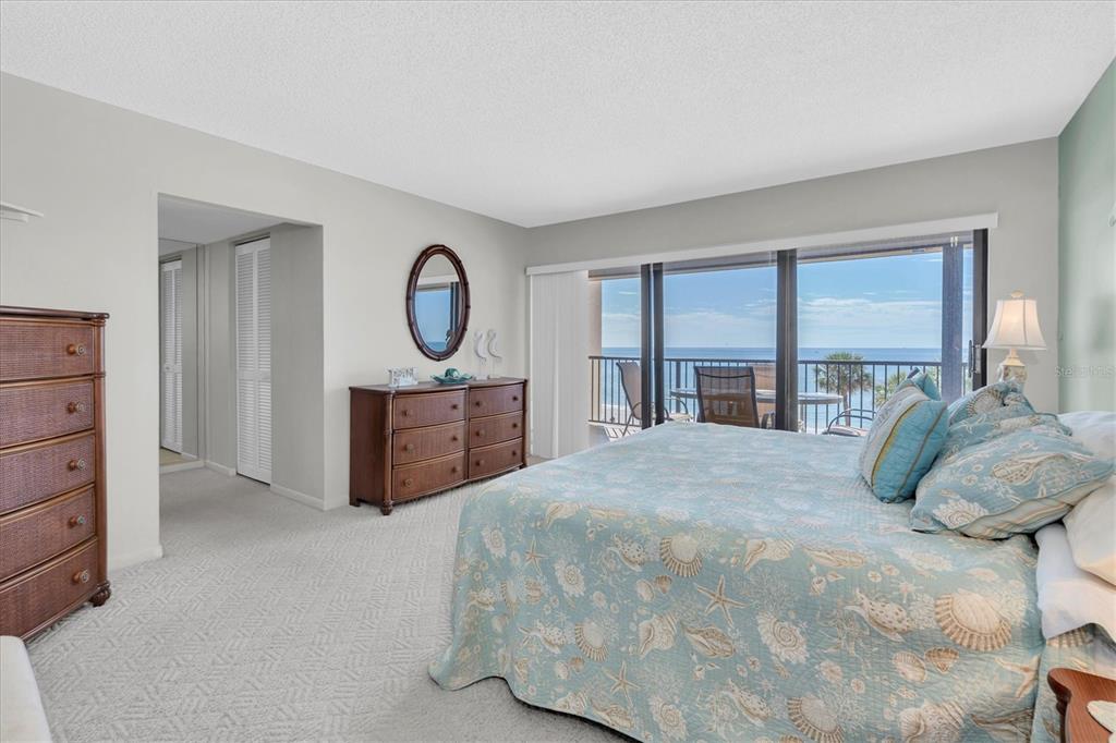14950 Gulf Boulevard, Unit 402 Madeira Beach, FL 33708 - Photo 11 of 36 a bedroom with a bed and a dresser