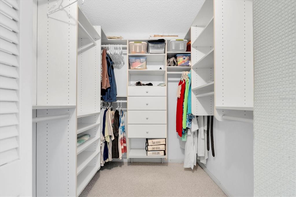 14950 Gulf Boulevard, Unit 402 Madeira Beach, FL 33708 - Photo 15 of 36 a view of walk in closet with clothes and shoes