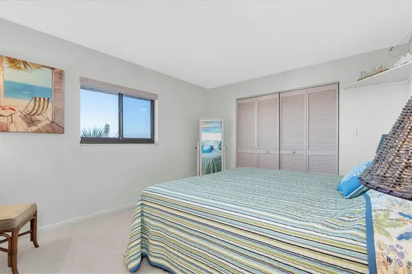 a bedroom with a bed and a lamp