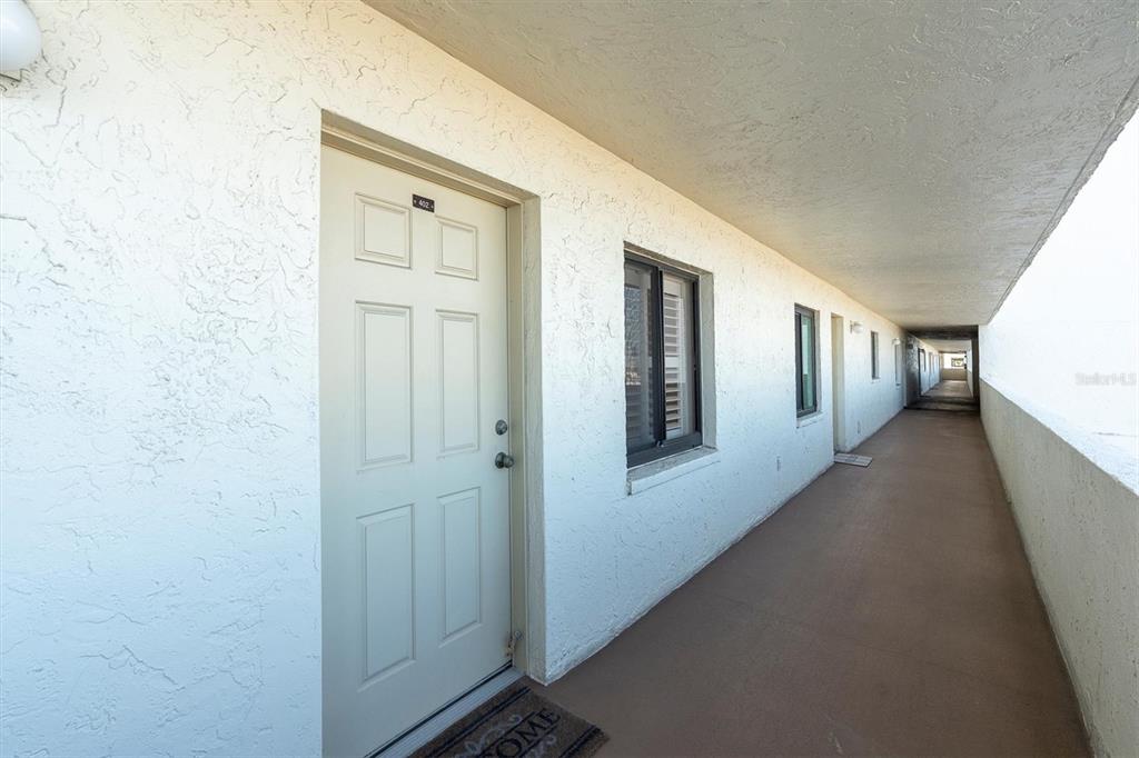 14950 Gulf Boulevard, Unit 402 Madeira Beach, FL 33708 - Photo 27 of 36 a hallway with windows and stairs