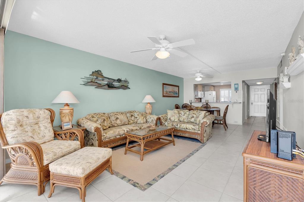 14950 Gulf Boulevard, Unit 402 Madeira Beach, FL 33708 - Photo 4 of 36 a living room with furniture and a flat screen tv