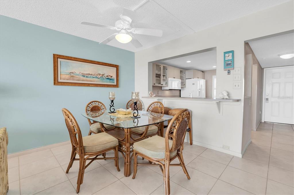 14950 Gulf Boulevard, Unit 402 Madeira Beach, FL 33708 - Photo 5 of 36 a view of a dining room with furniture