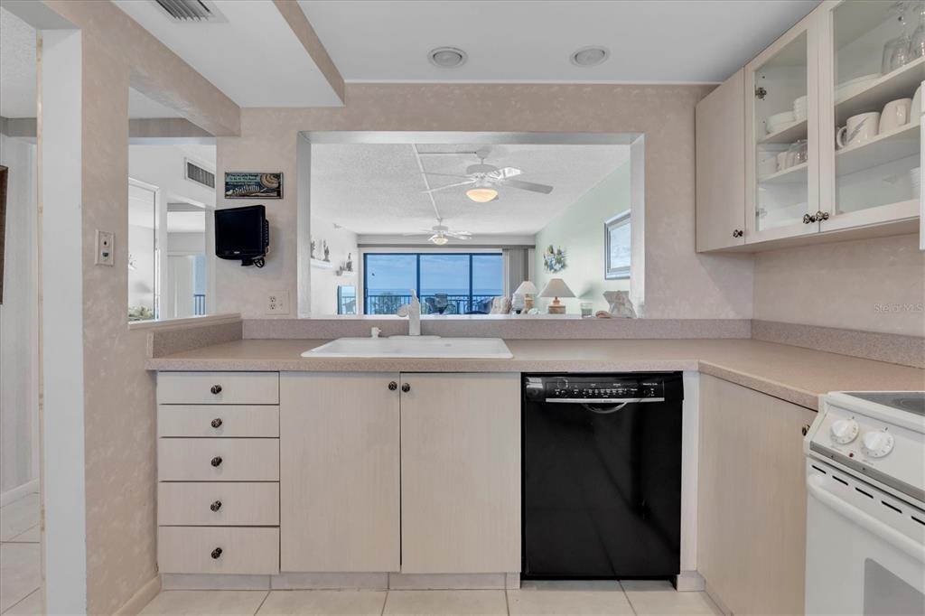 14950 Gulf Boulevard, Unit 402 Madeira Beach, FL 33708 - Photo 9 of 36 a kitchen with cabinets appliances and a counter space