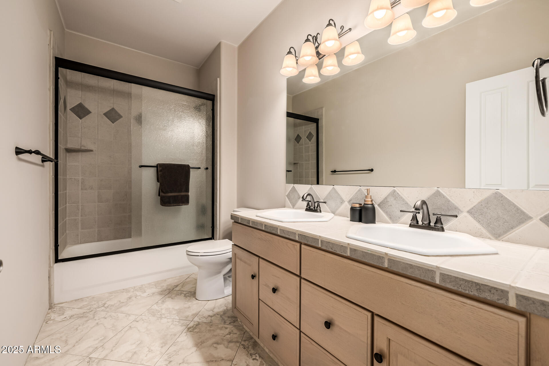 1815 West Sentinel Rock Road Phoenix, AZ 85086 - Photo 30 of 58 a bathroom with a toilet sink double vanity and mirror