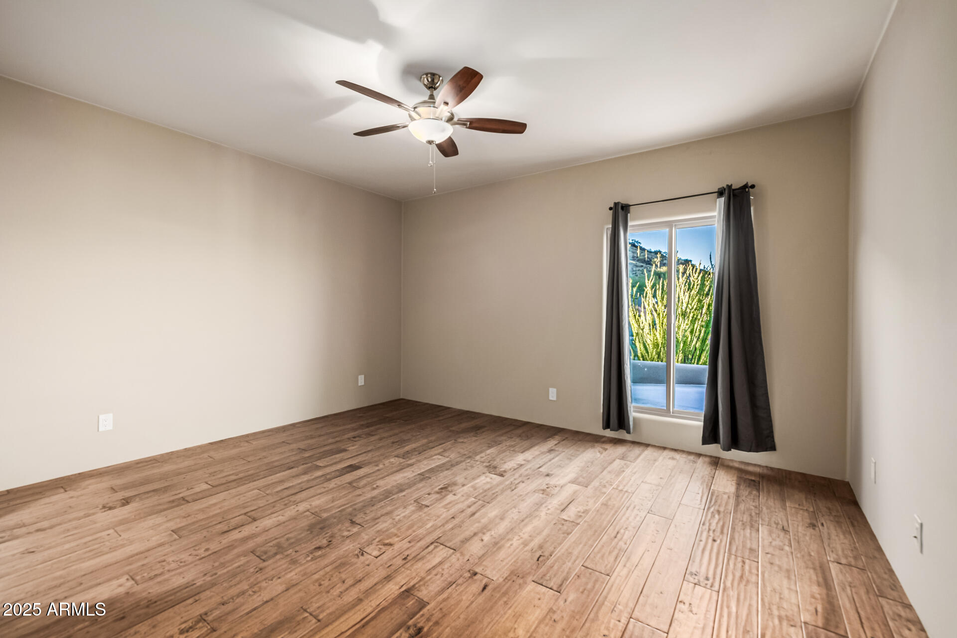 1815 West Sentinel Rock Road Phoenix, AZ 85086 - Photo 38 of 58 a view of an empty room with window and wooden floor