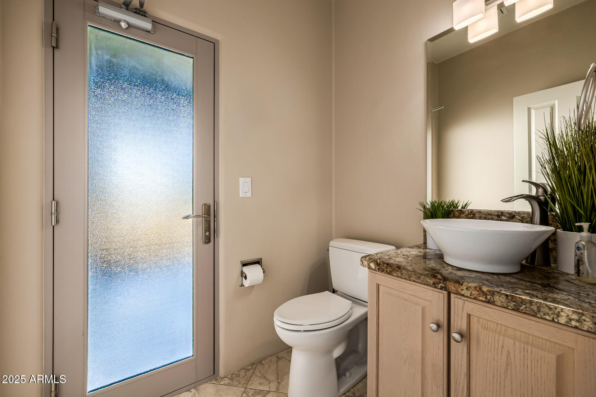 1815 West Sentinel Rock Road Phoenix, AZ 85086 - Photo 42 of 58 a bathroom with a granite countertop toilet a sink and a mirror