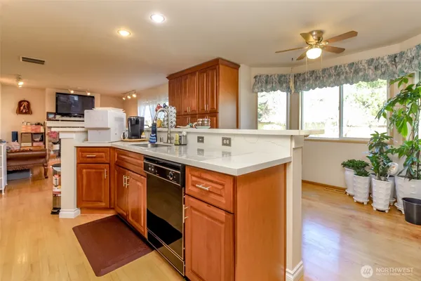 a kitchen with a sink appliances and cabinets