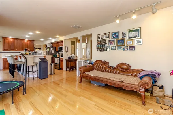 a living room with lots of furniture and kitchen view