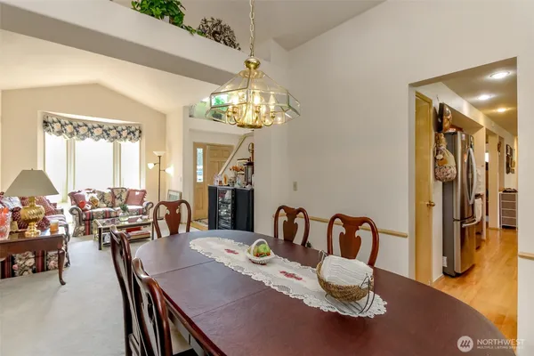 a living room with furniture flowers and a chandelier