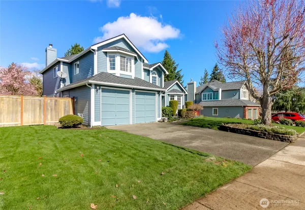 a front view of a house with a garden and plants