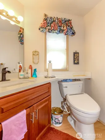 a bathroom with a toilet sink and mirror