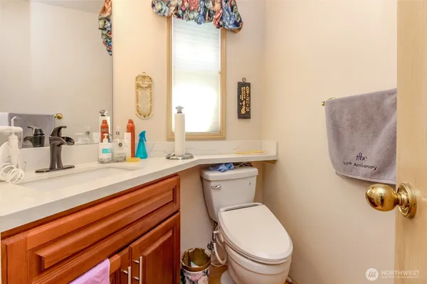 a bathroom with a toilet sink and mirror