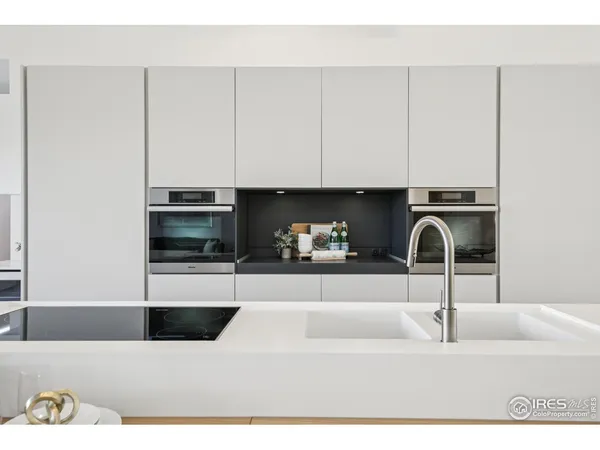 a kitchen with a sink and white cabinets