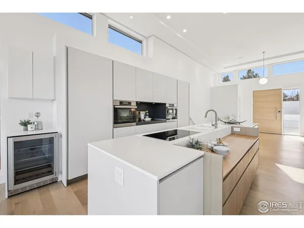 a kitchen with stainless steel appliances granite countertop a sink a stove and a refrigerator