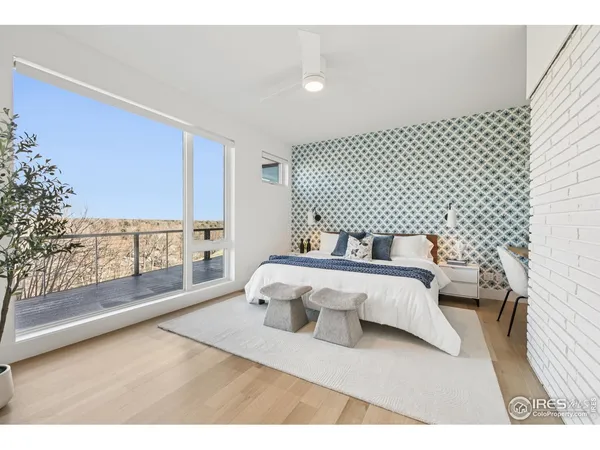 a spacious bedroom with a bed and a large window