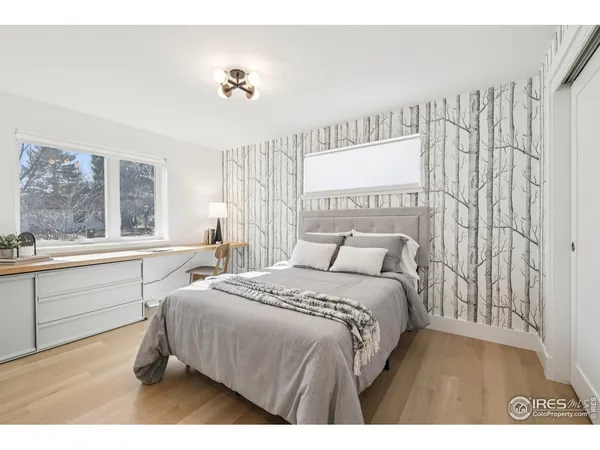 a bedroom with a bed and a large window