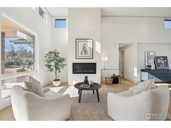 a living room with furniture a large window and a flat screen tv