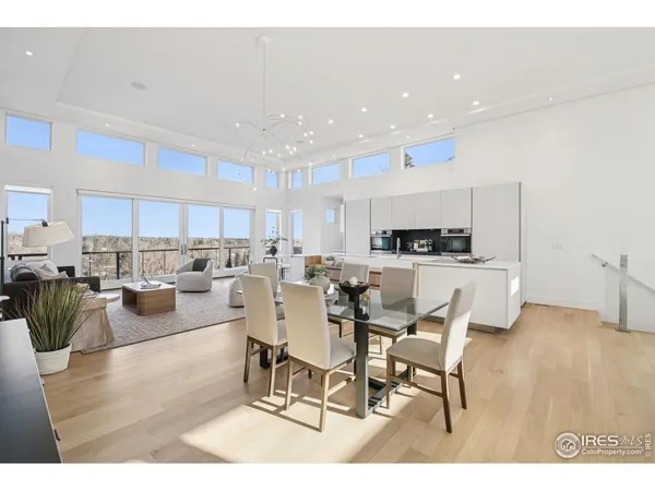 a living room with lots of furniture and kitchen view