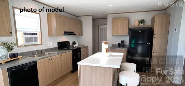 a kitchen with a sink a refrigerator and cabinets