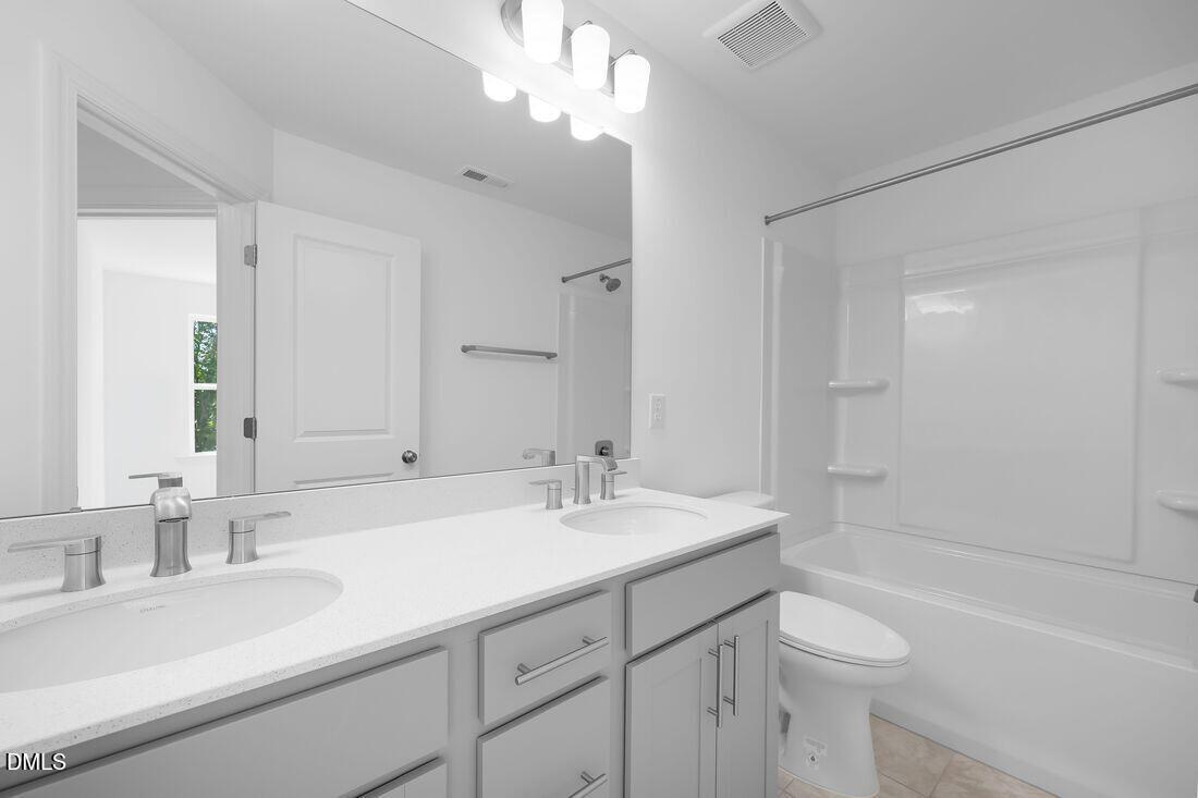 430 Rowe Way Knightdale, NC 27545 - Photo 25 of 51 a bathroom with a sink double vanity granite tub and a mirror