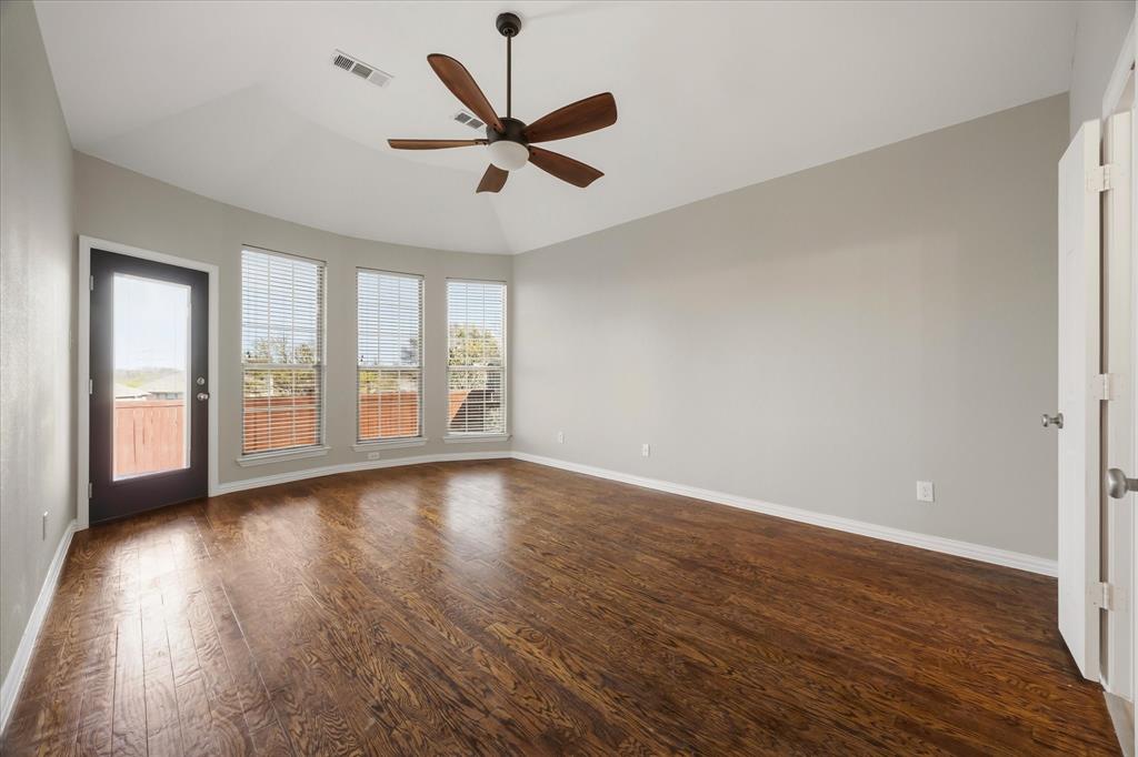 118 Stone Drive Forney, TX 75126 - Photo 11 of 26 an empty room with wooden floor and windows