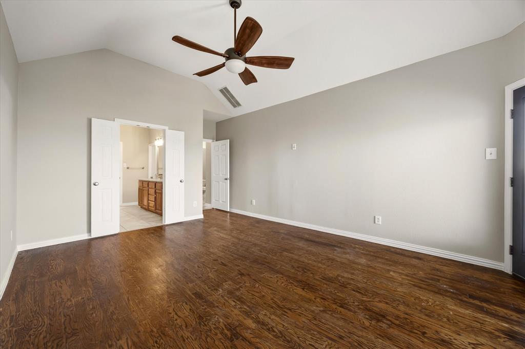 118 Stone Drive Forney, TX 75126 - Photo 12 of 26 a view of a big room with wooden floor and windows