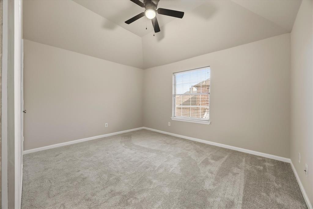 118 Stone Drive Forney, TX 75126 - Photo 21 of 26 an empty room with a window and a fan