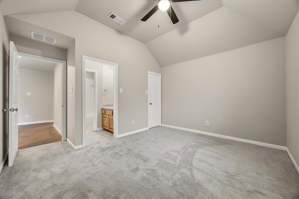 118 Stone Drive Forney, TX 75126 - Photo 22 of 26 an empty room with chandelier fan and kitchen view