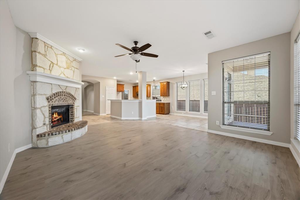 118 Stone Drive Forney, TX 75126 - Photo 3 of 26 a view of an empty room with a fireplace and a window