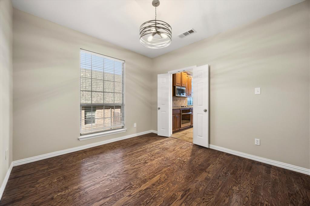118 Stone Drive Forney, TX 75126 - Photo 7 of 26 wooden floor in an empty room with a window