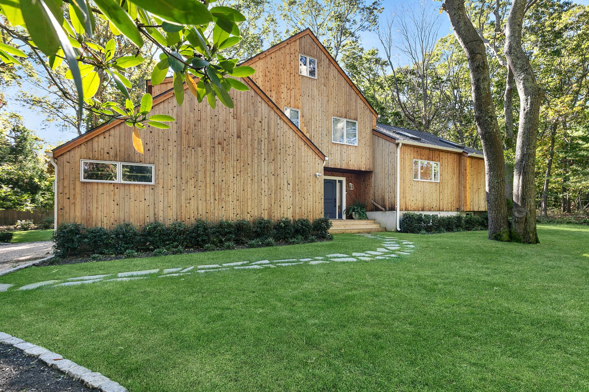 a front view of house with yard and green space