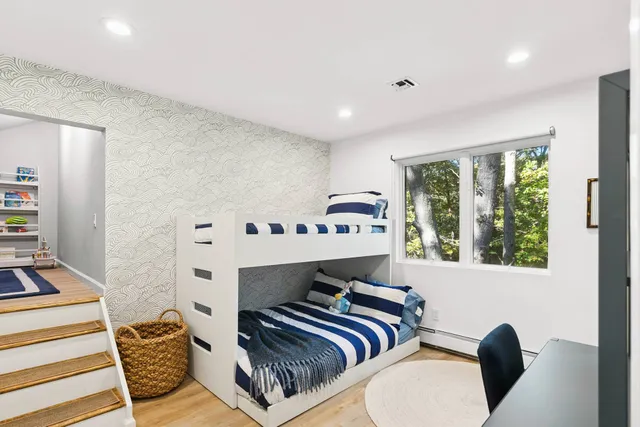 a bedroom with furniture and a window