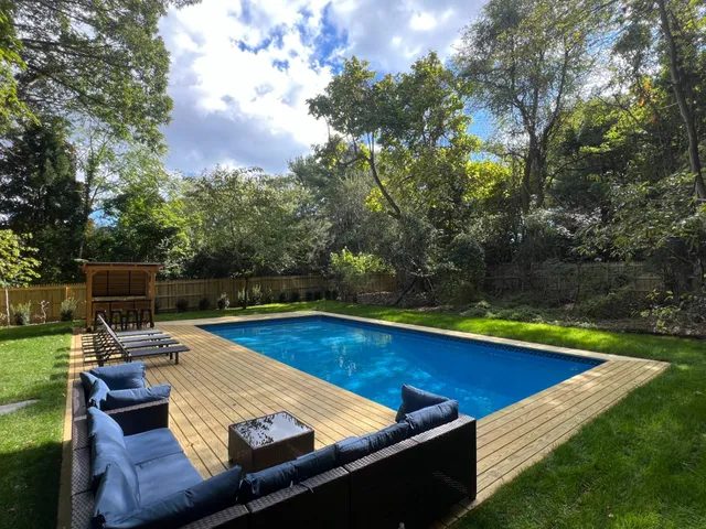 a view of swimming pool with chairs and couch