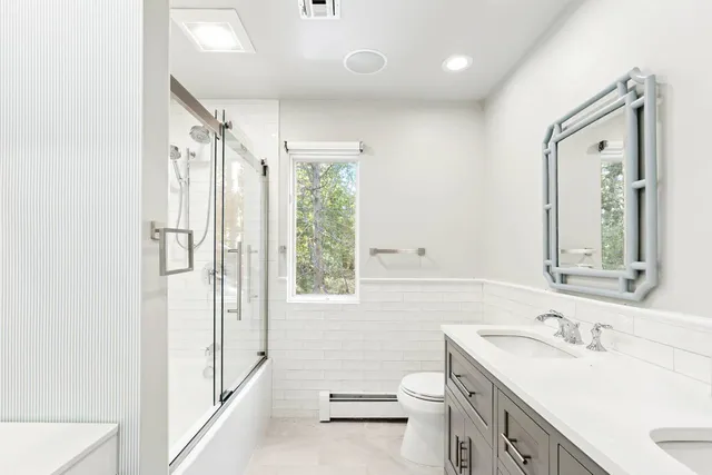 a bathroom with a sink toilet and shower