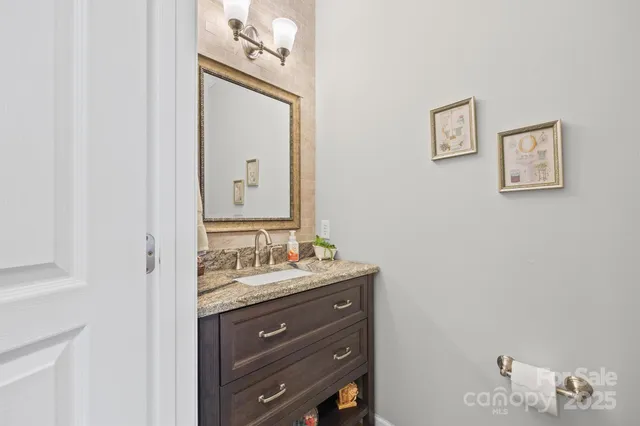 a living room with furniture a chandelier and a flat screen tv