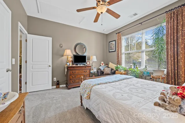 a bedroom with bed and a flat screen tv