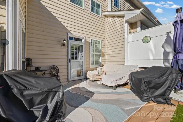 a view of a house with swimming pool and sitting area