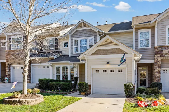 a front view of a house with swimming pool table and chairs