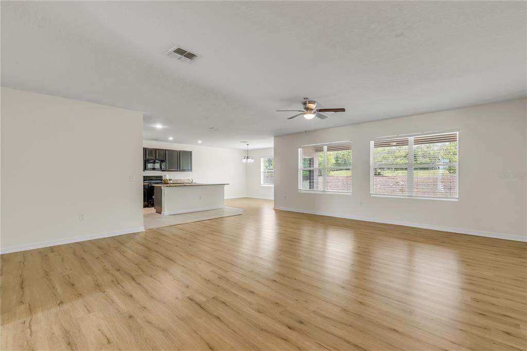 48 Hickory Loop Ocala, FL 34472 - Photo 8 of 52 an empty room with wooden floor and windows